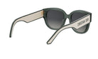 A pair of green-framed sunglasses with the brand name "Christian Dior" printed on the side.
