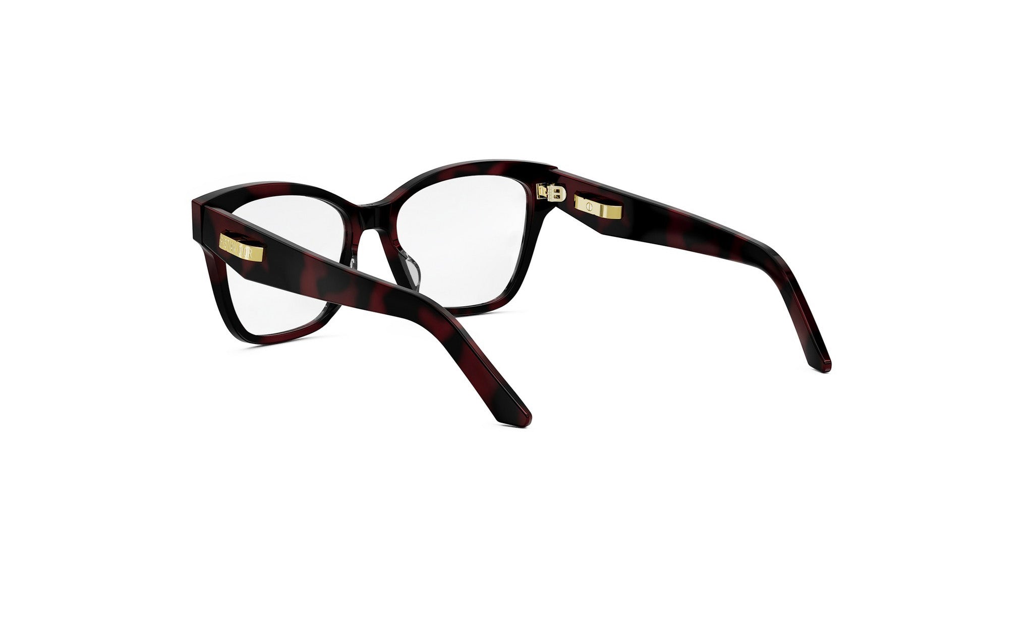 A pair of dark-colored, tortoiseshell-patterned glasses with gold accents, positioned facing towards the right side of the image.