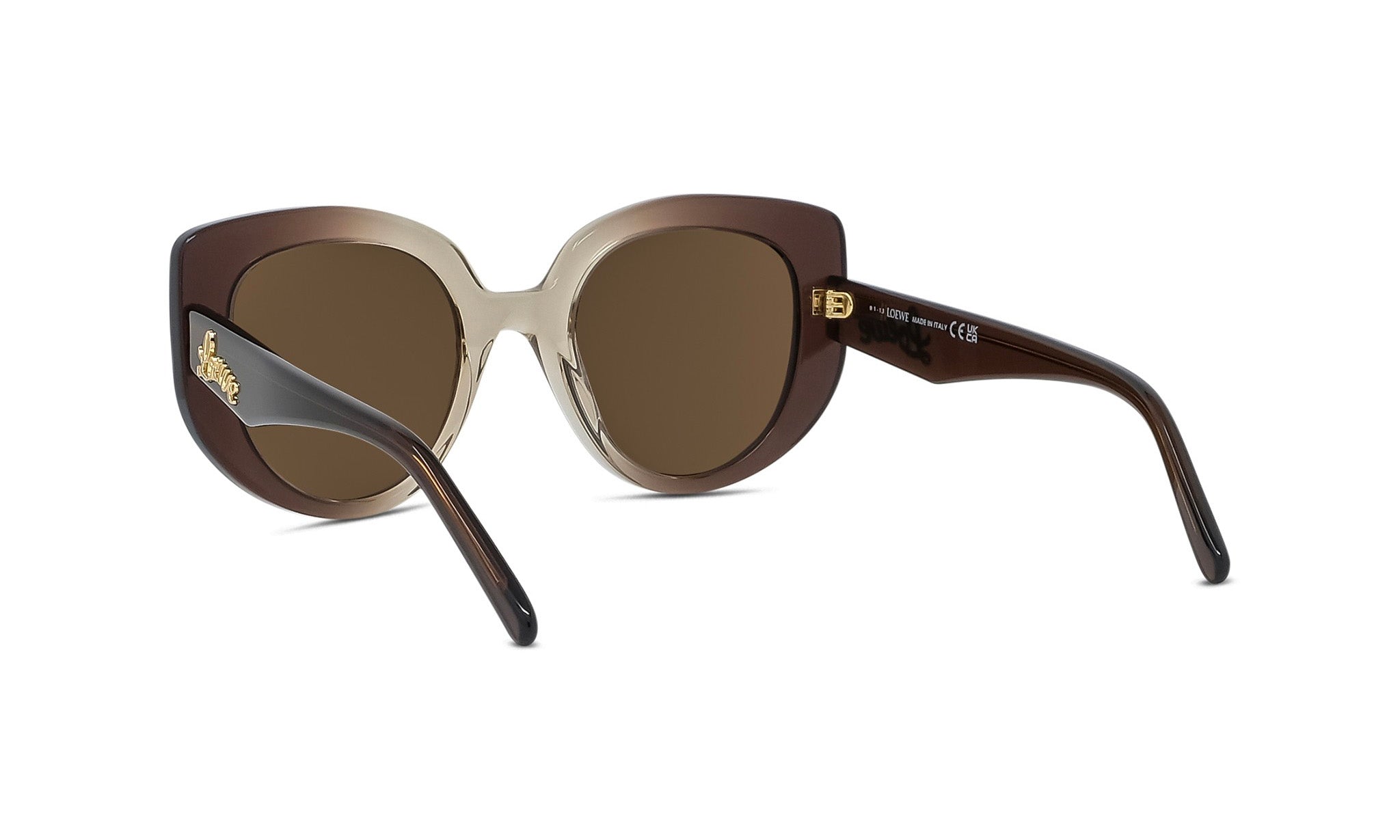 A pair of brown and tan cat-eye sunglasses with gold accents, featuring a large central lens and a smaller frame.