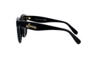 A pair of black sunglasses with gold text on the frame.