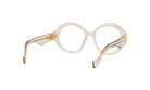 A pair of round, clear eyeglasses with gold-colored metal accents.