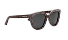 A pair of brown cat-eye sunglasses with the brand name "Christian Dior" printed on the frame.