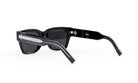 A pair of black sunglasses with a silver frame and the Dior logo visible on the frame.