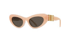 A pair of peach-colored cat-eye sunglasses with dark lenses.