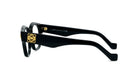A pair of black-framed glasses with a gold logo on the temples.